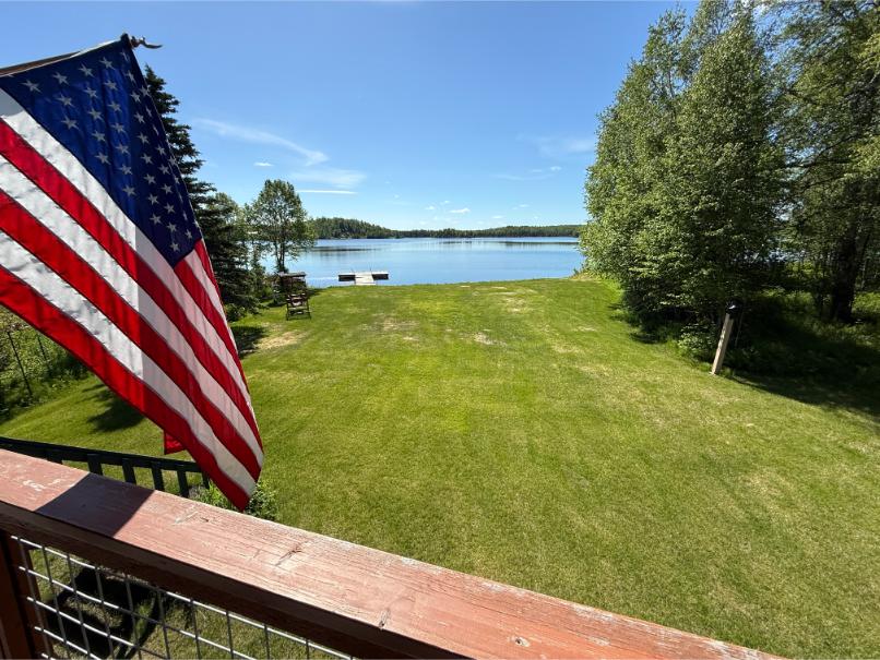 Lakefront property in Alaska with waterfront lawn, private shoreline, and panoramic lake views.