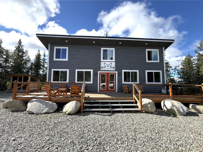 Remote Alaska home on 7 wooded acres with road access, two cabins, and private airstrip.